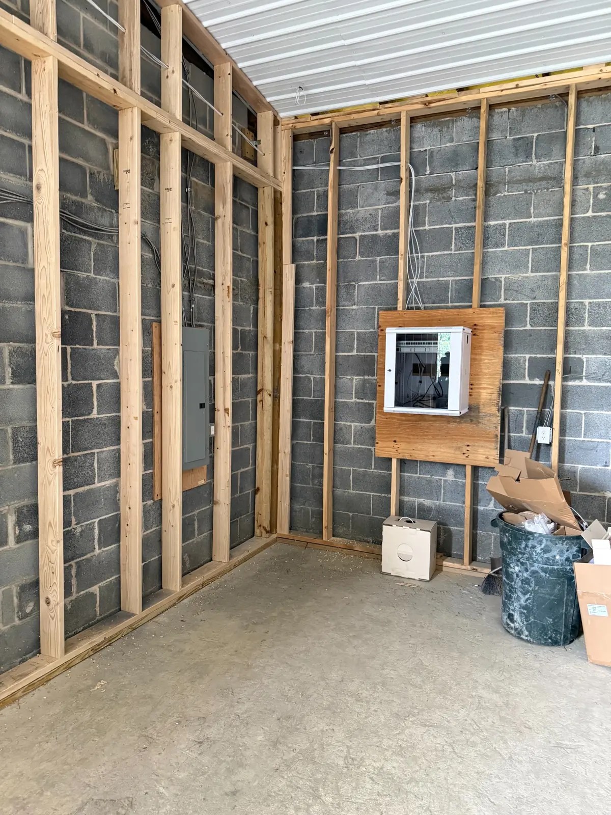 Commercial communications room under construction with wall-mount IDF cabinet and coordinated pathways