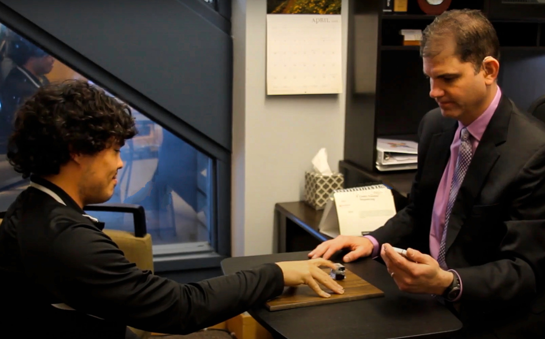 This image appears to be from a consultancy session between a doctor and male patients.