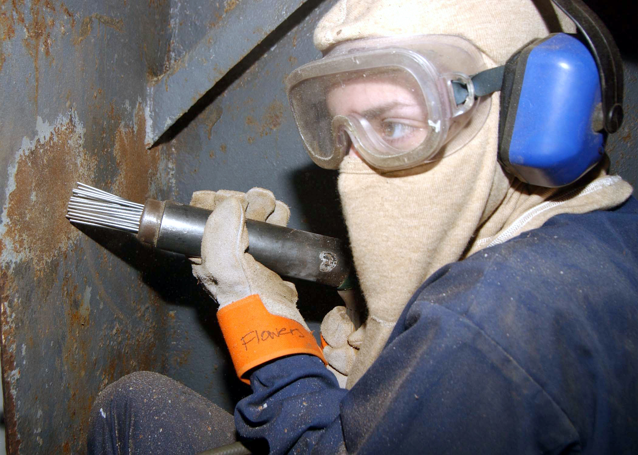 030121-N-6651N-003
Aboard USS John F. Kennedy (CV 67) Jan. 21, 2003 -- Aerographer's Mate 3rd Class Rebecca A. Flowers uses a needle gun to removes layers of paint, during painting and preservation efforts aboard ship.  Kennedy is undergoing a $250 million overhaul in it homeport of Mayport, Fla.  U.S. Navy photo by Photographer's Mate Airman Monica R. Nelson.  (RELEASED)