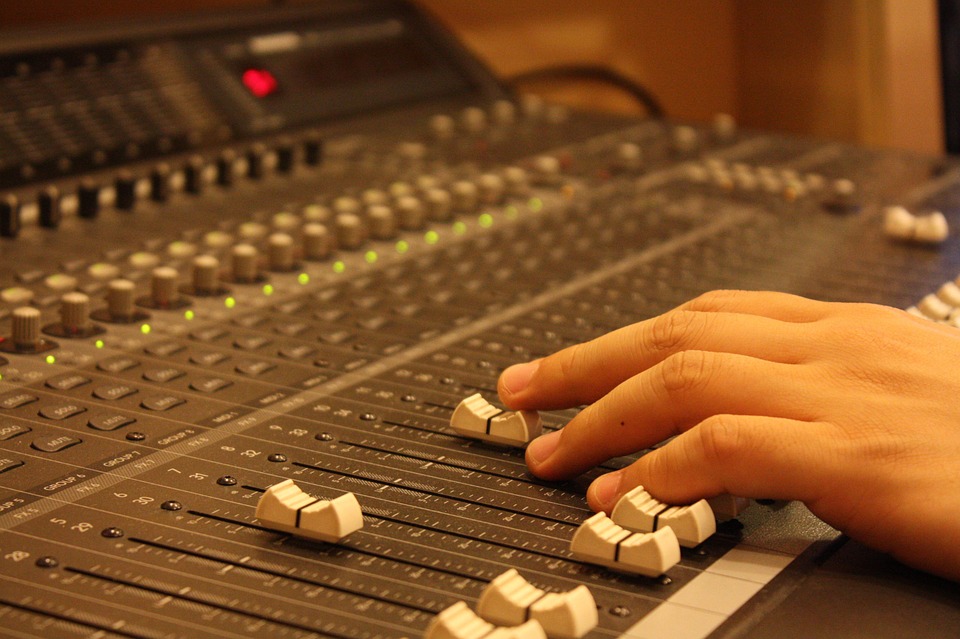 A depiction of a mixing board, illustrating a discussion of sound design iteration in game development - as included in the article by video game composer Winifred Phillips.