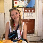 Jenna sitting with a plate of food