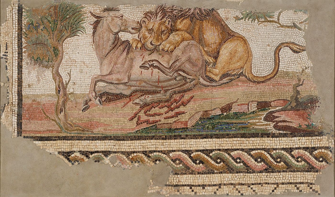 Ancient mosaic depicting a lion attacking a horse, with the lion biting the horse’s back and the scene surrounded by trees and a patterned border at the bottom.