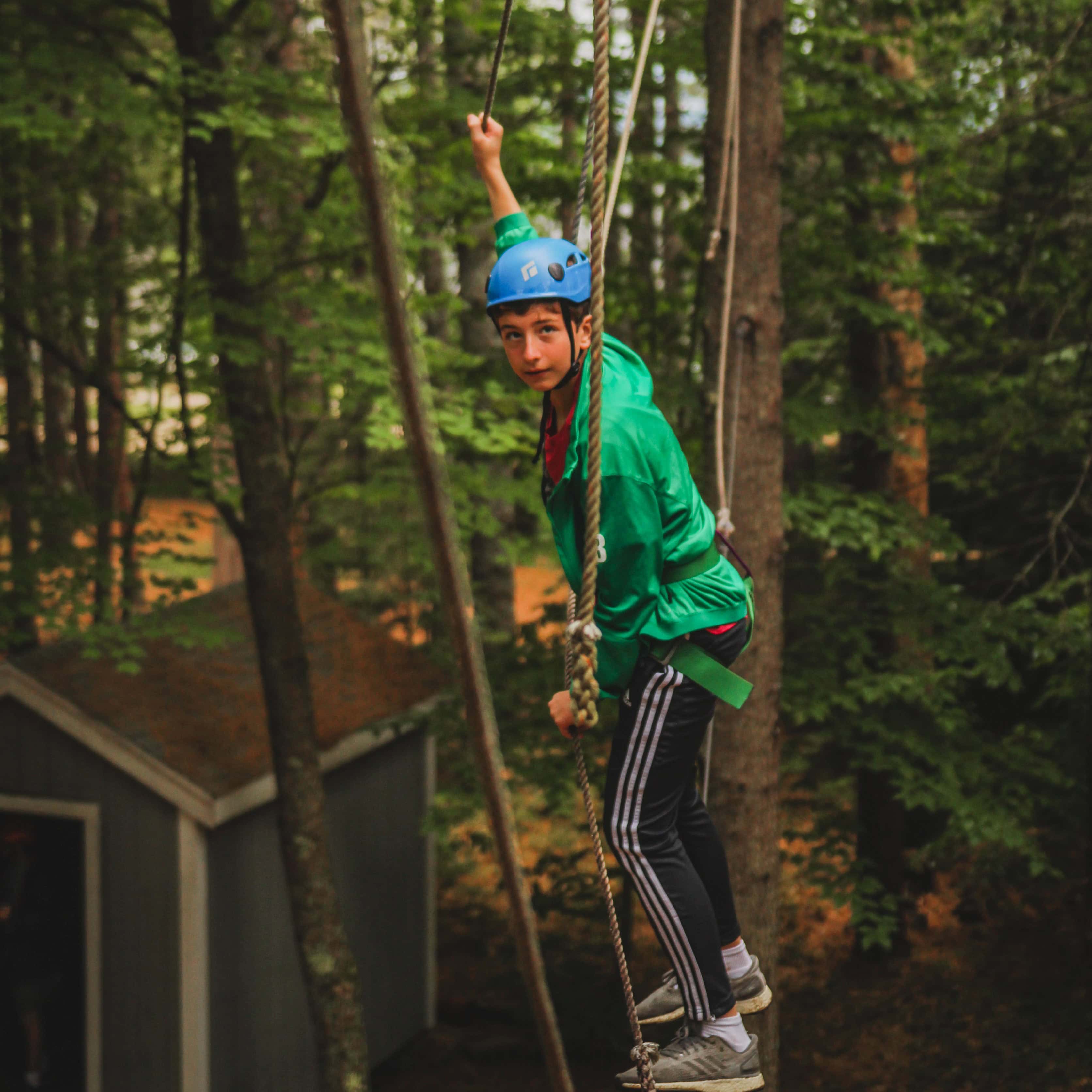 High ropes course being navigated by a camper at camp