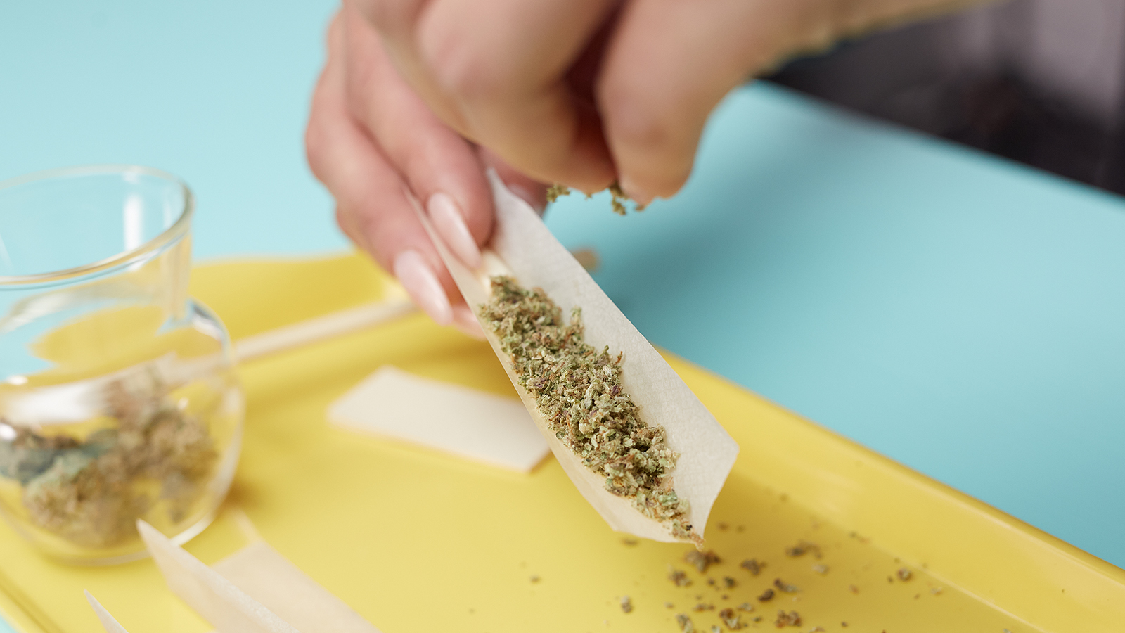 Loading a rolling paper with weed