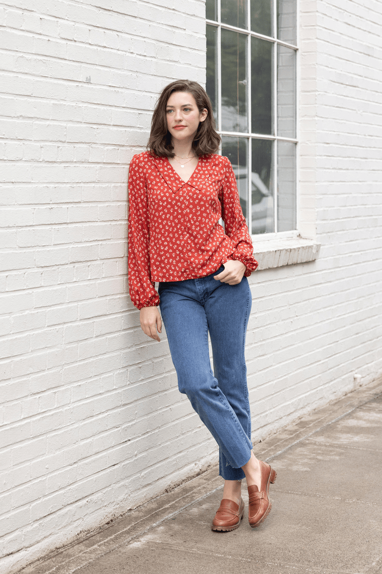 a woman wearing a red long sleeve blouse sewing pattern