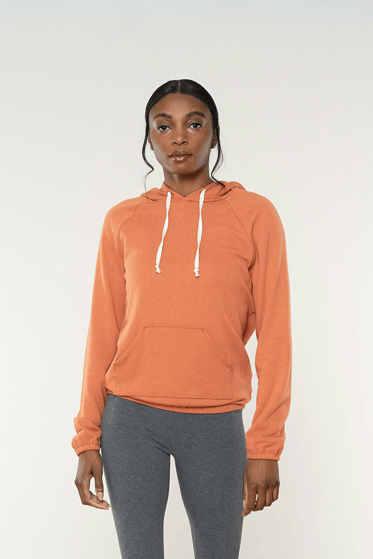 a woman wearing an orange fleece hooded sweatshirt sewing pattern