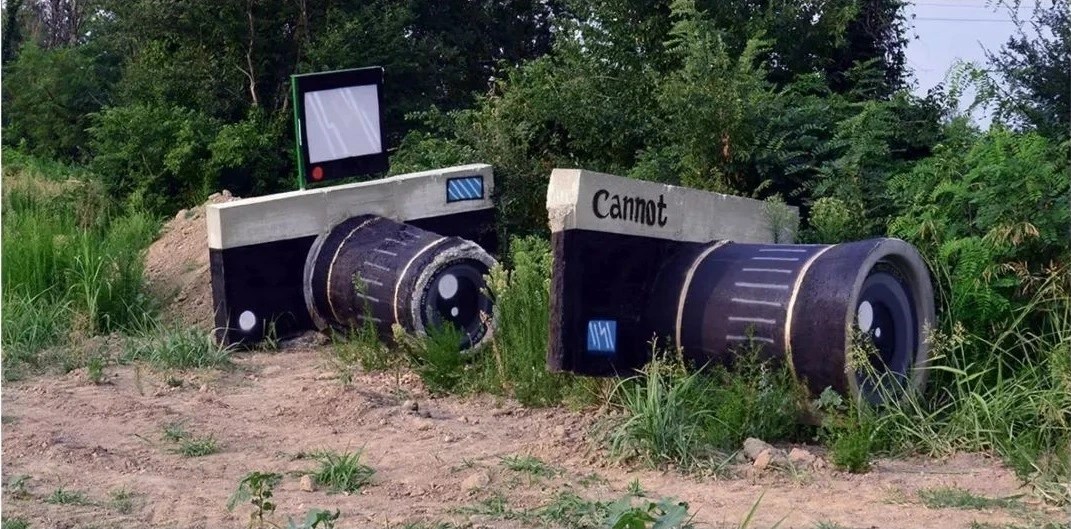 CANNOT by Biancoshock in Lodi, Italy: concrete forms painted to resemble two cameras.