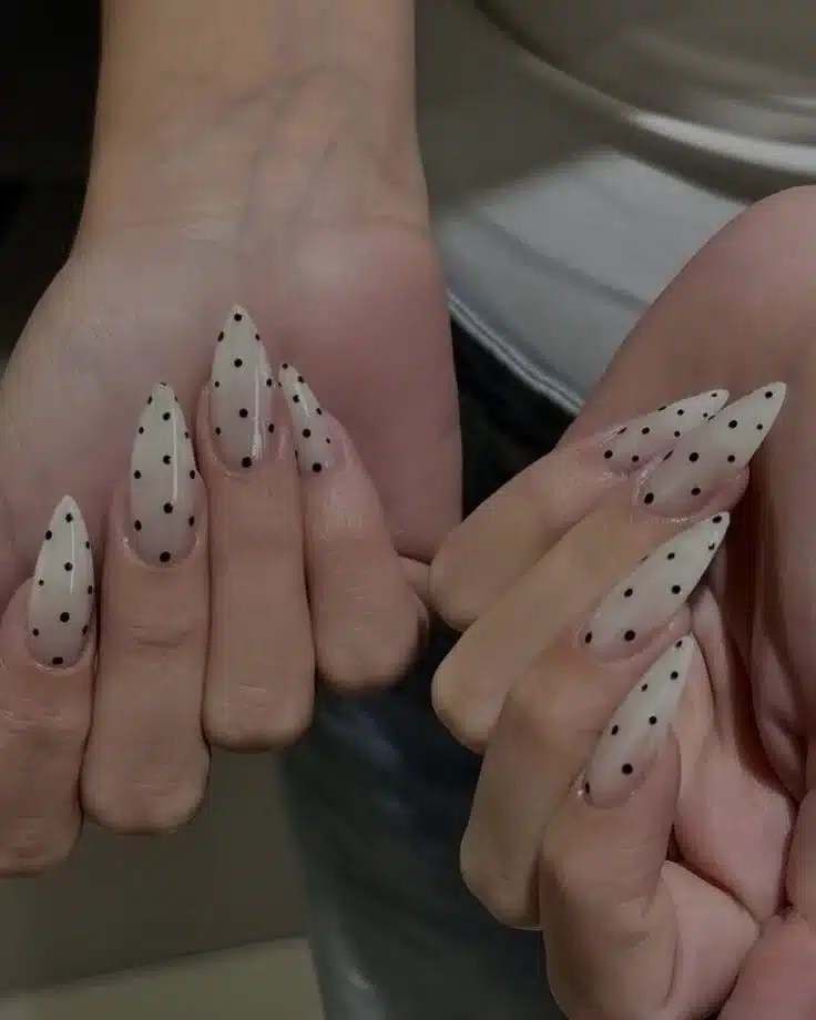 Almond-shaped nails with delicate polka dot nail art design
