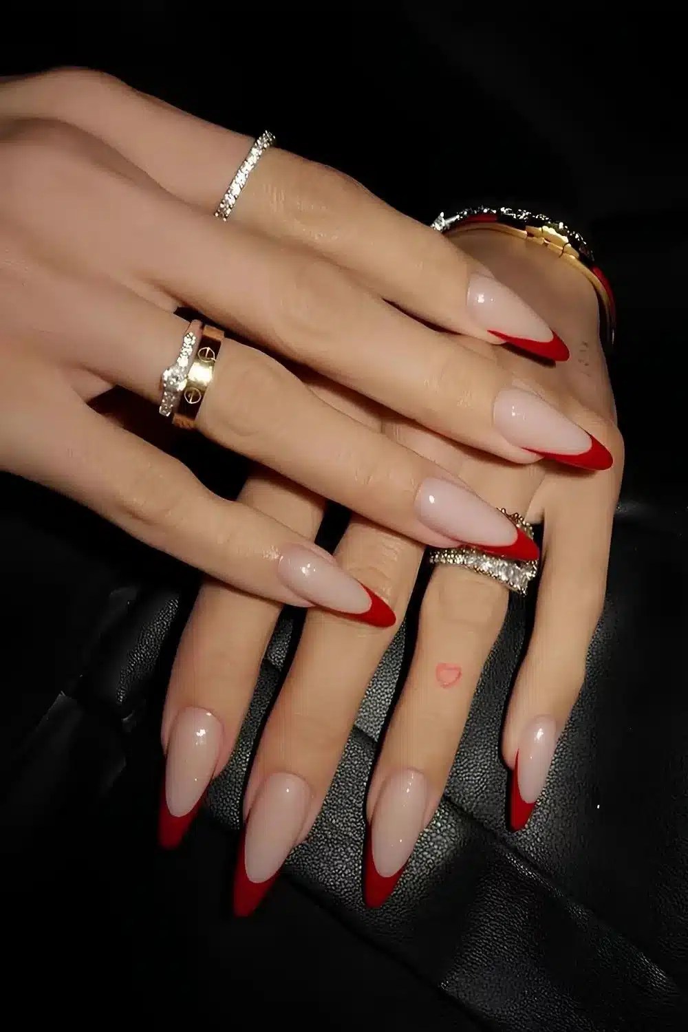 French manicure with bold red tips on almond-shaped nails