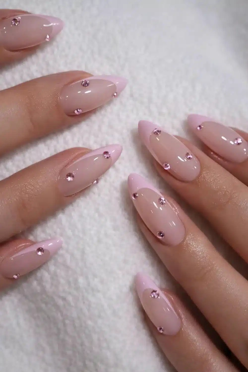 Pink French manicure featuring rhinestone nail embellishments