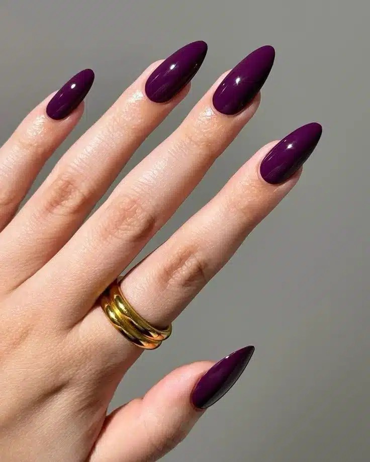 Plum purple manicure styled as a graduation nail design