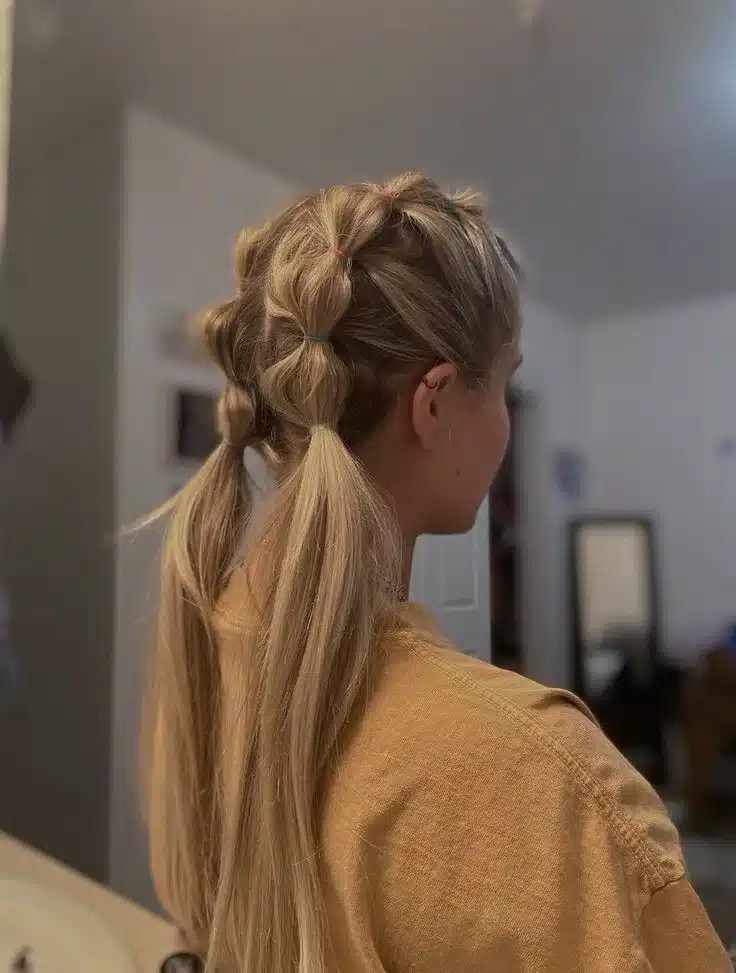 Messy bubble braids styled into a fun pool hairstyle that's perfect for summer holidays, swimming, beach days, and keeping long hair secure.