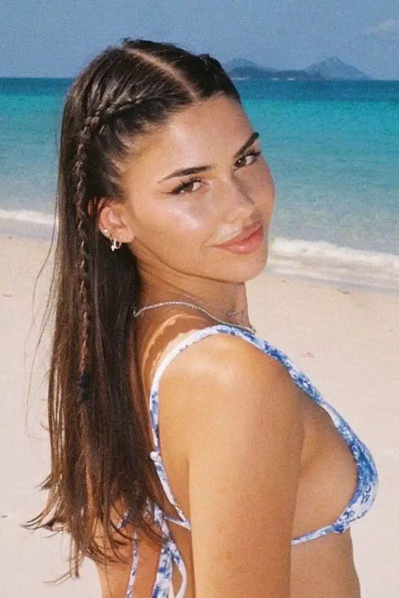 Classic French plait hairstyle designed for swimming and pool days, keeping long hair secure while creating a timeless summer hairstyle.