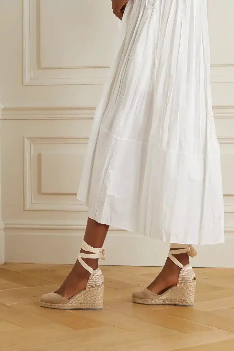 White maxi dress paired with wedge sandals creating a timeless summer outfit ideal for holidays, dinners, and European travel.