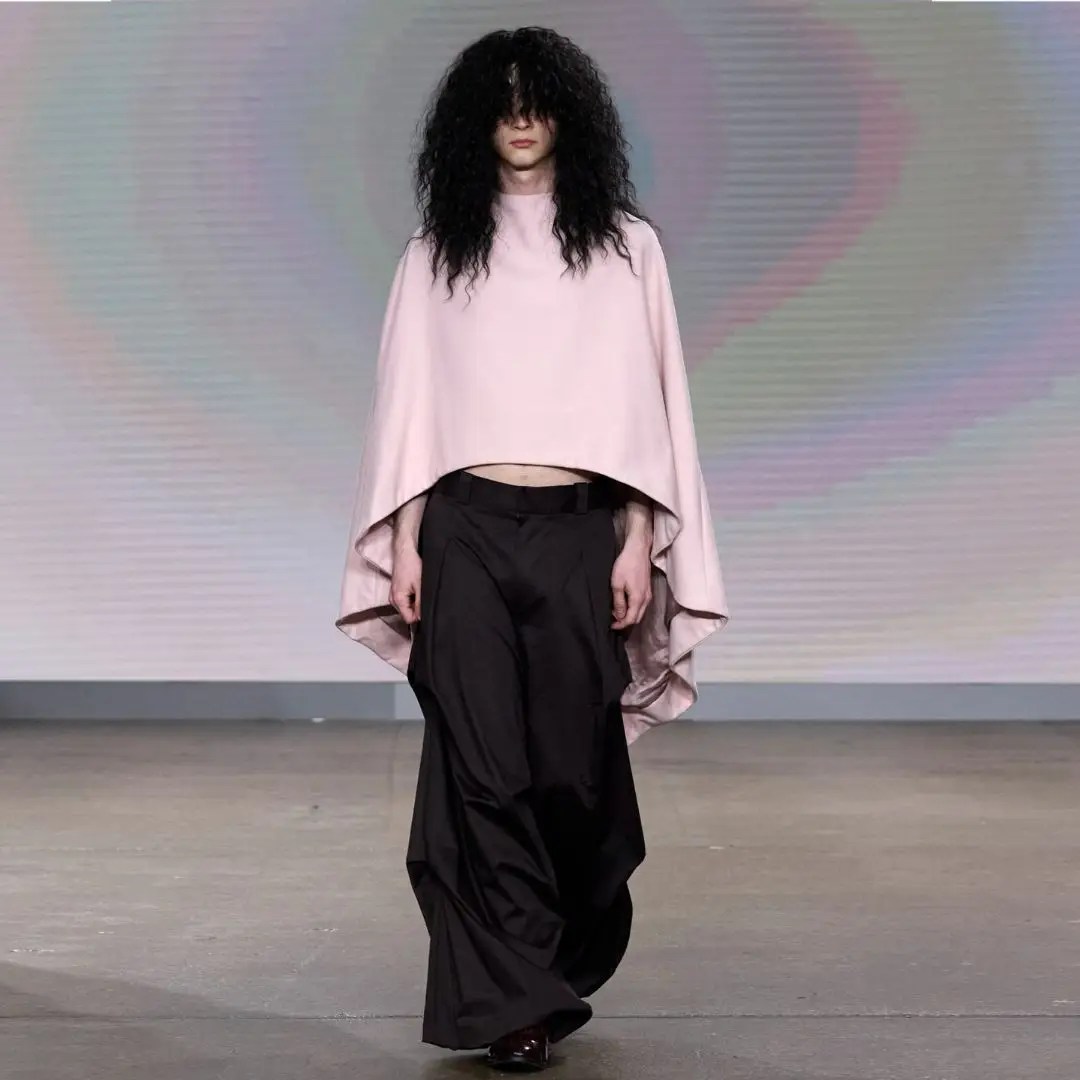 Catwalk Trends Worth Recreating featuring a pastel pink cape-style top paired with dramatic black wide-leg trousers on the runway
