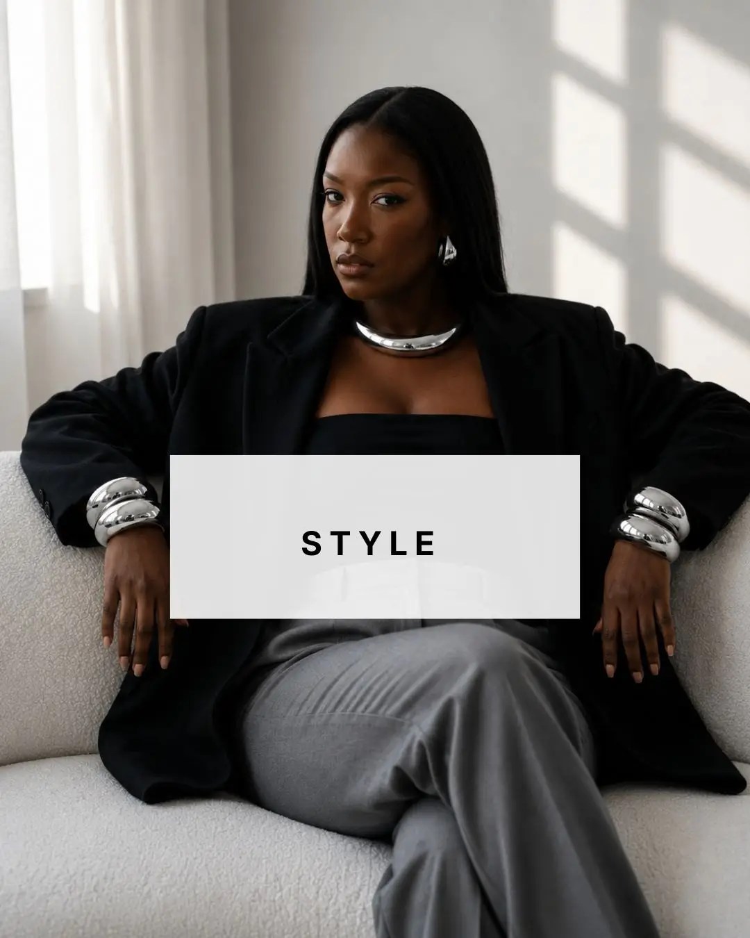 Wots Her Name Again style featuring a Black woman in relaxed tailoring with statement silver jewellery.