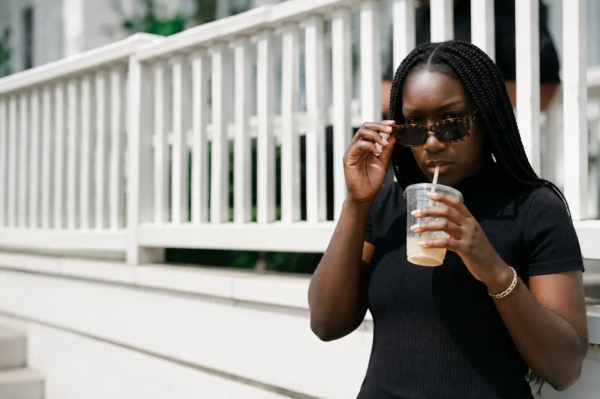 Lee-Anne wearing a timeless black dress and tortoiseshell sunglasses, showcasing personal style through effortless everyday fashion and confident dressing.