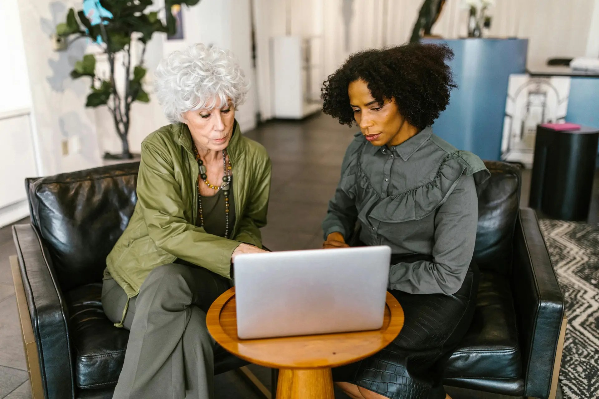 Women discussing Working And Personal Independence Payment support and Lupus benefits information on a laptop