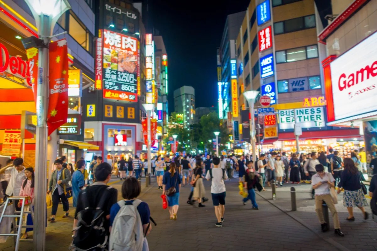 TOKYO, JAPAN JUNE 28 - 2017: Crowd of people walking at night in the streets of Ikebukuro, a commercial and entertainment district in Toshima, Tokyo
