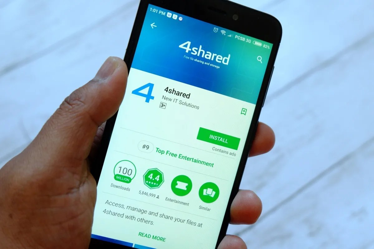 BANDAR SERI BEGAWAN, BRUNEI - JULY 25TH, 2018: A male hand holding smartphone with 4shared apps on an android Google Play Store
