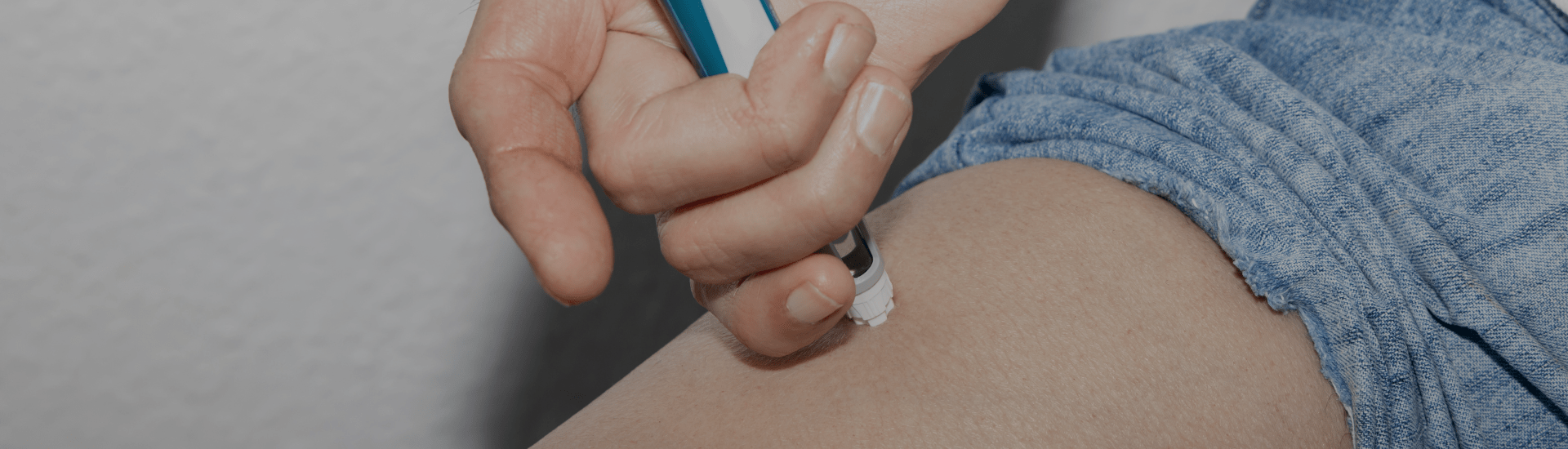 Woman injecting weight loss medication in her leg