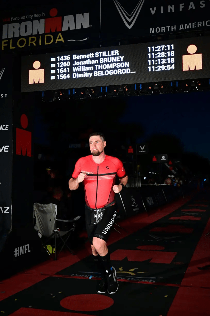 Bennett Stiller crossing IRONMAN finish line