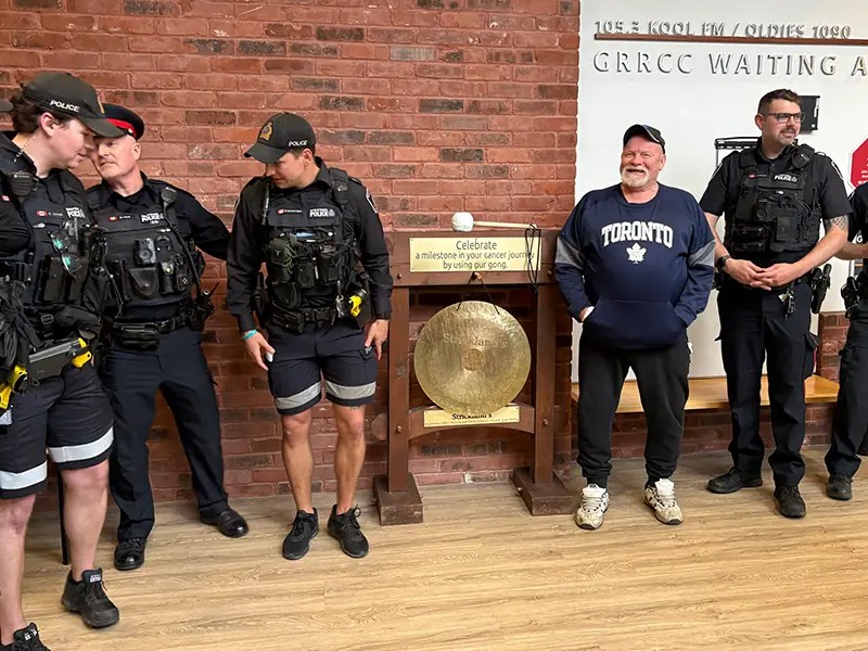 Photo: Jeff Kalan and local police in front of the gong at WRHN @ Midtown