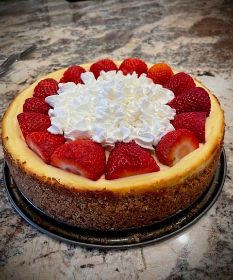 Strawberry cheesecake with whipped cream on top