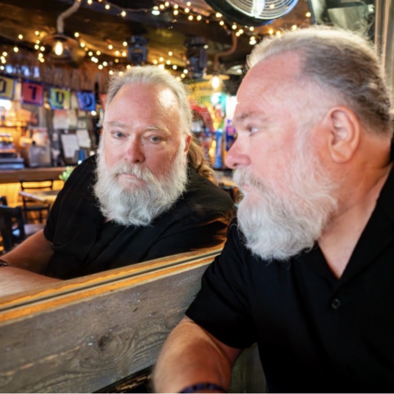 Poet R.G. Evans reflects in the mirror of a pub