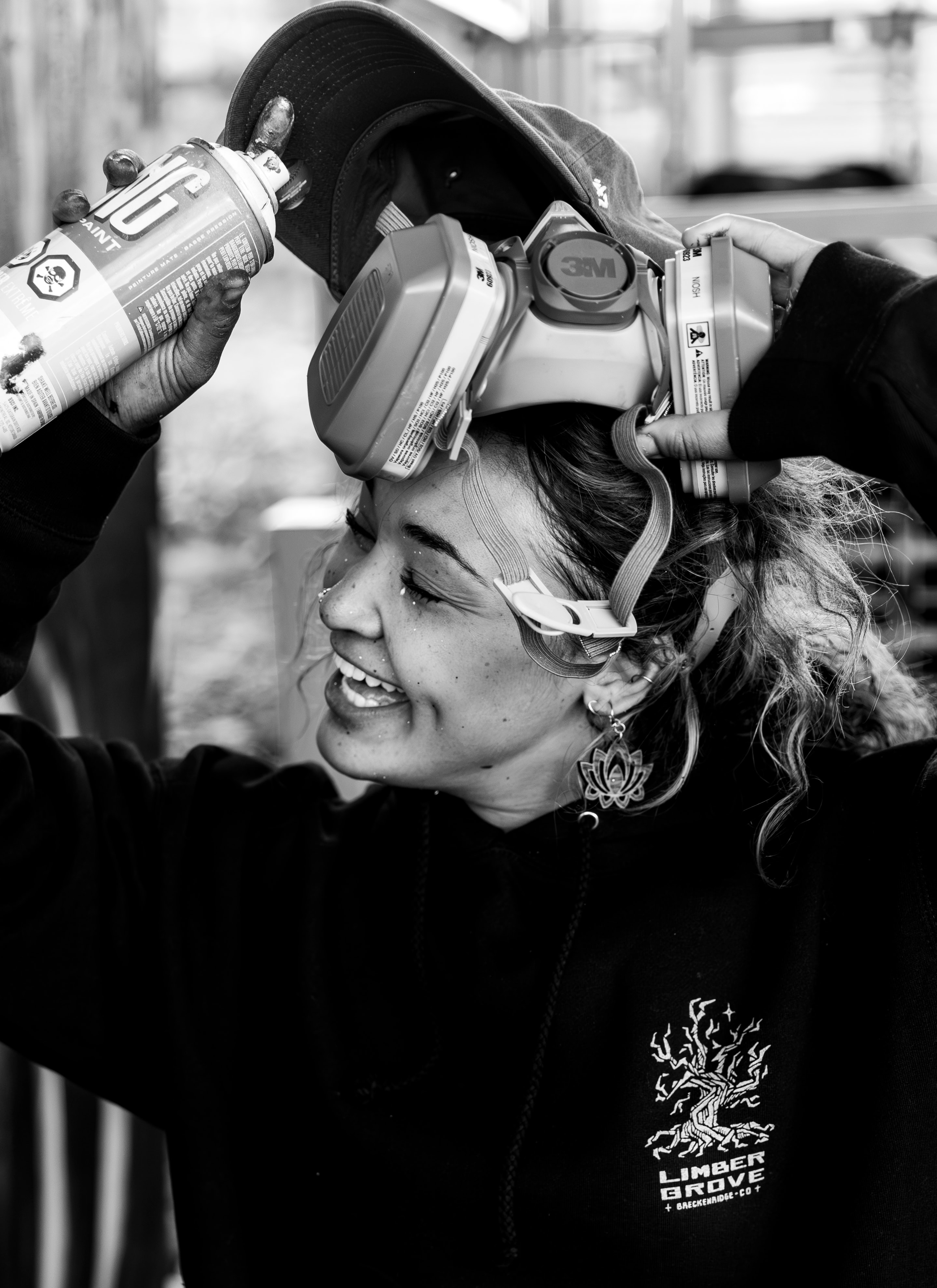 Fire safety technician applying a mask and holding a fire extinguisher outdoors, promoting fire safety and emergency preparedness.