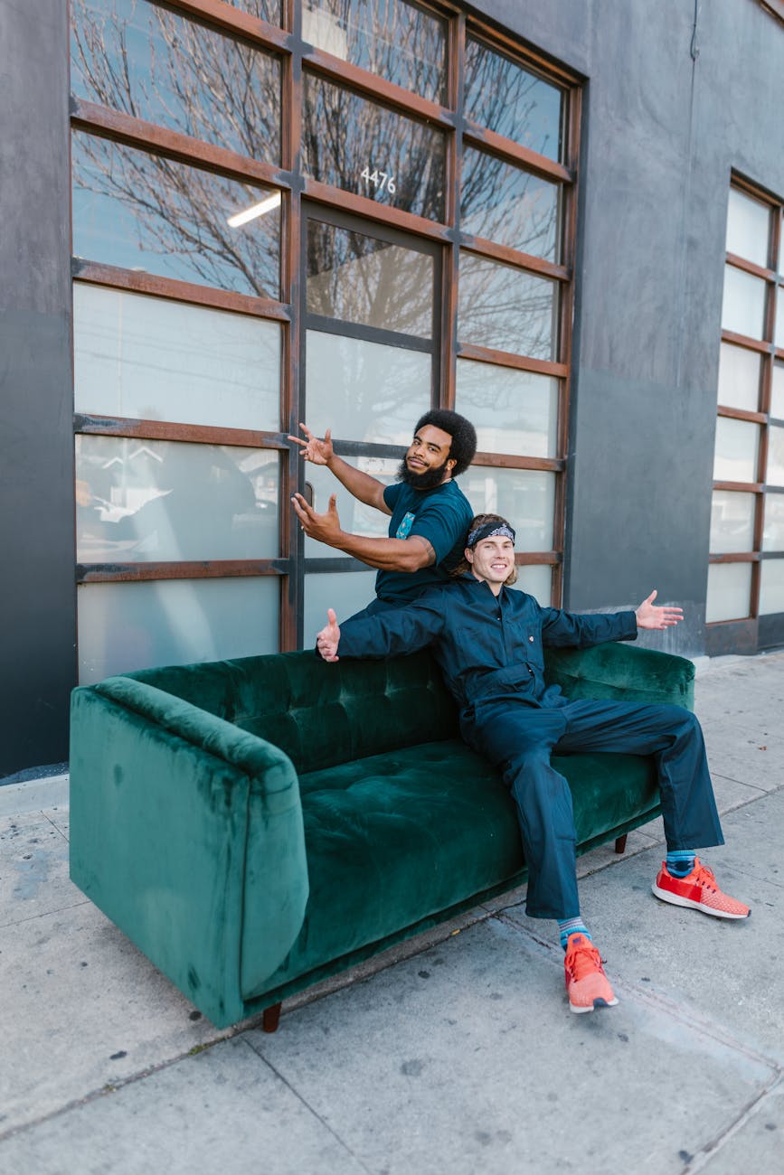 man and woman sitting on blue couch