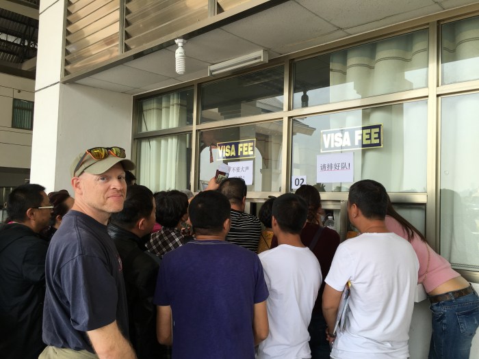 Waiting in "line" to get our passports back and pay for a Lao Visa.