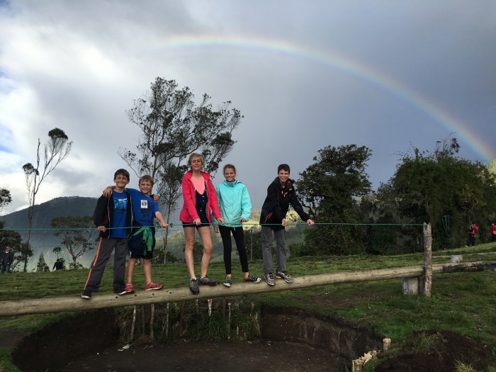 The kids pause their play for a photo worthy moment under a rainbow