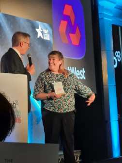 Claire Buckle on stage collecting her award