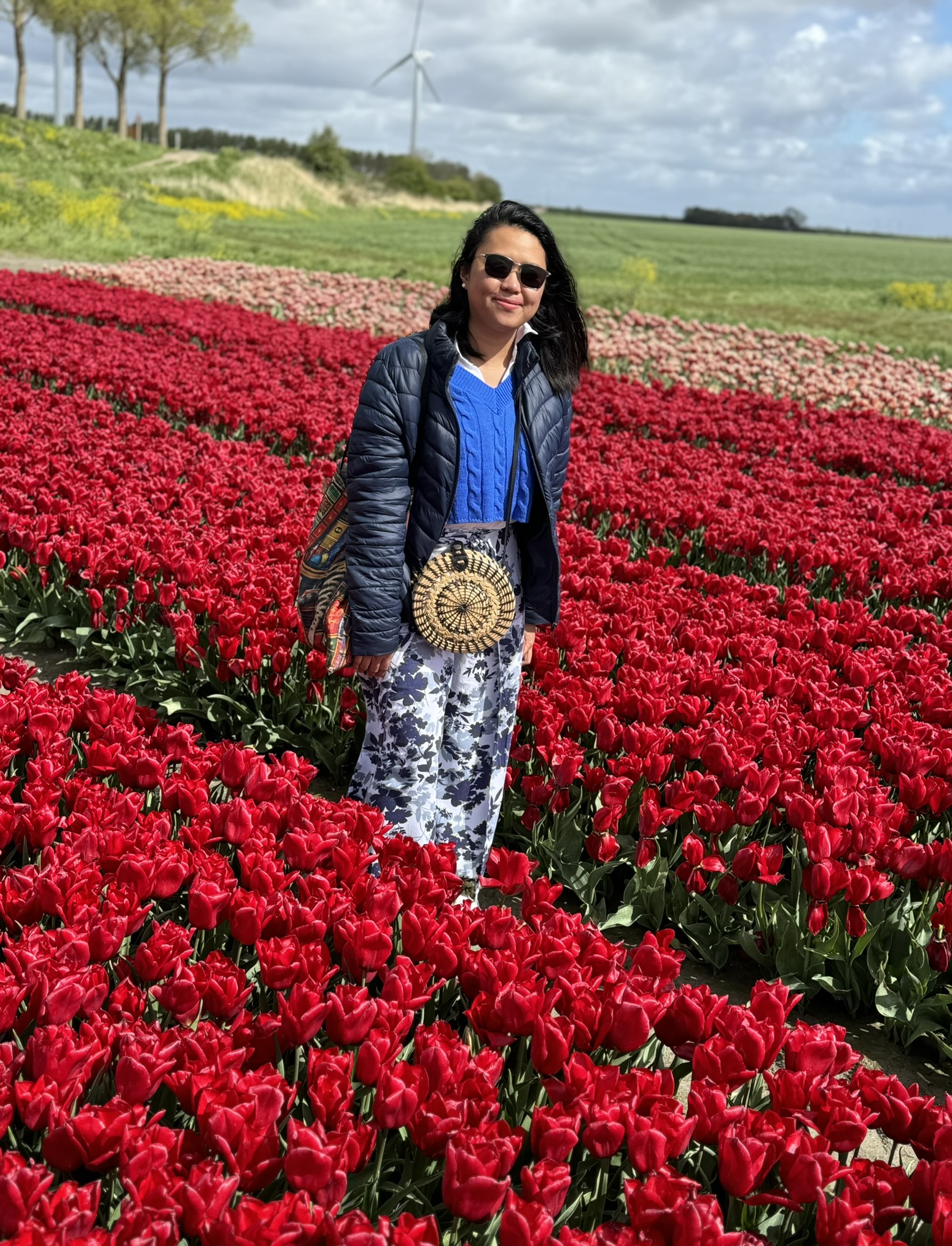 Woman standing on a field of tulips