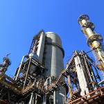low angle shot of manufacturing plant under blue sky
