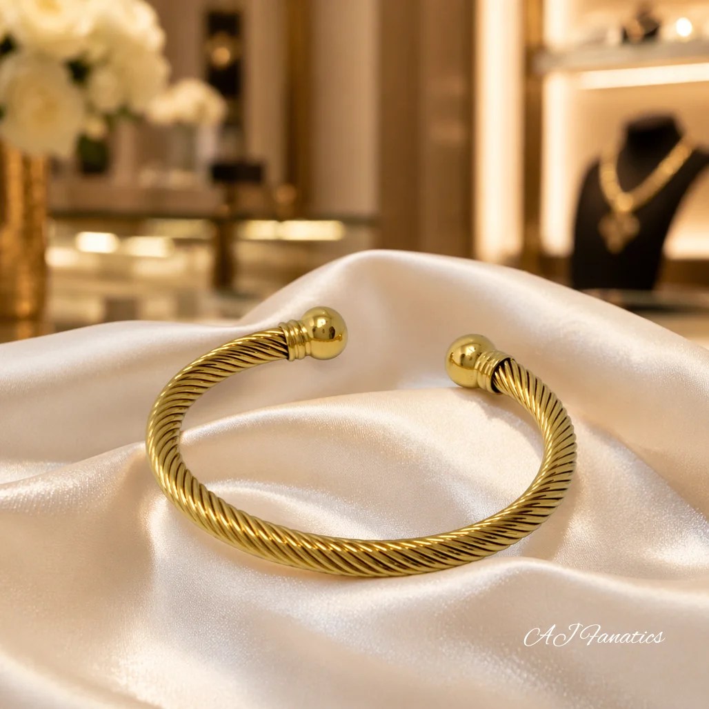 Gold twisted helix cuff bangle bracelet made of stainless steel, featuring polished sphere end-caps on an open-cuff design from The Fusion Collection.