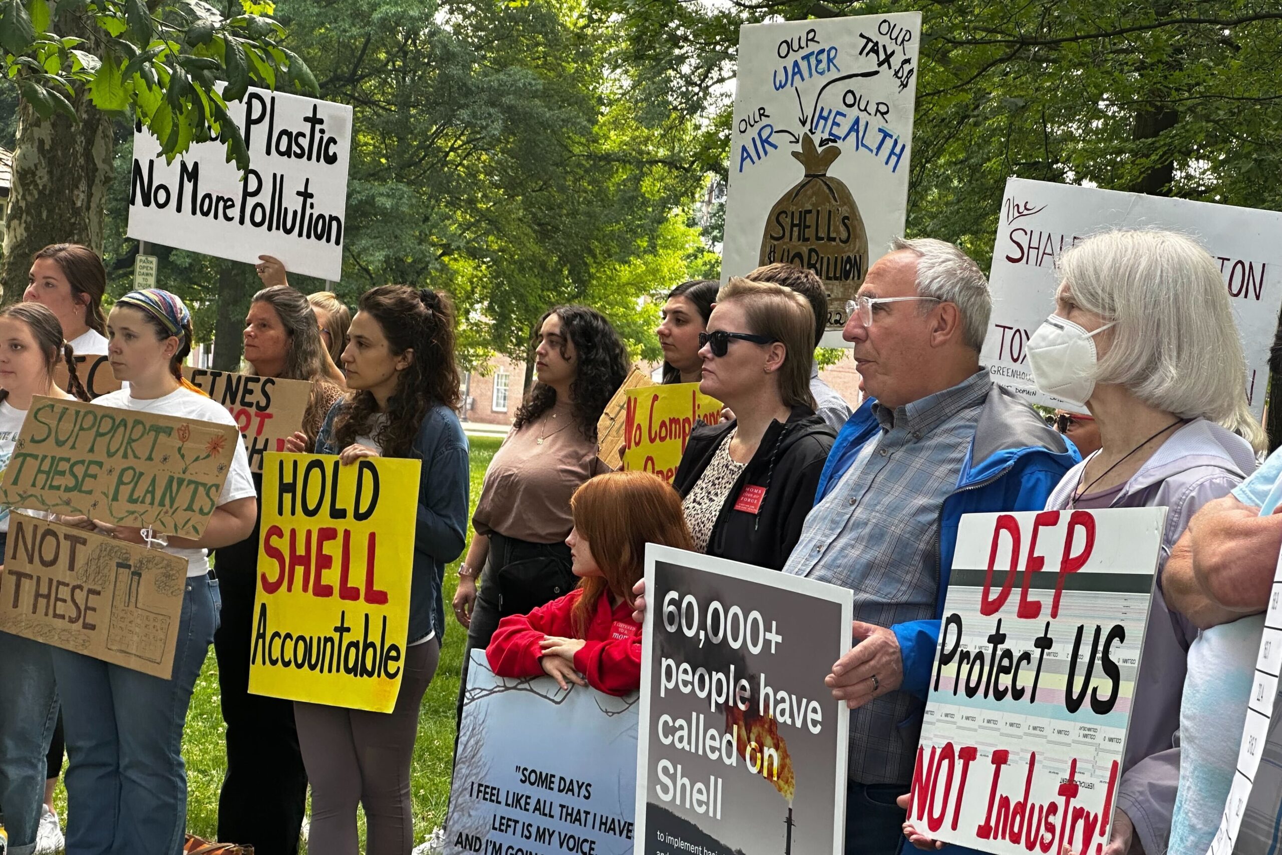 People at a rally holding signs