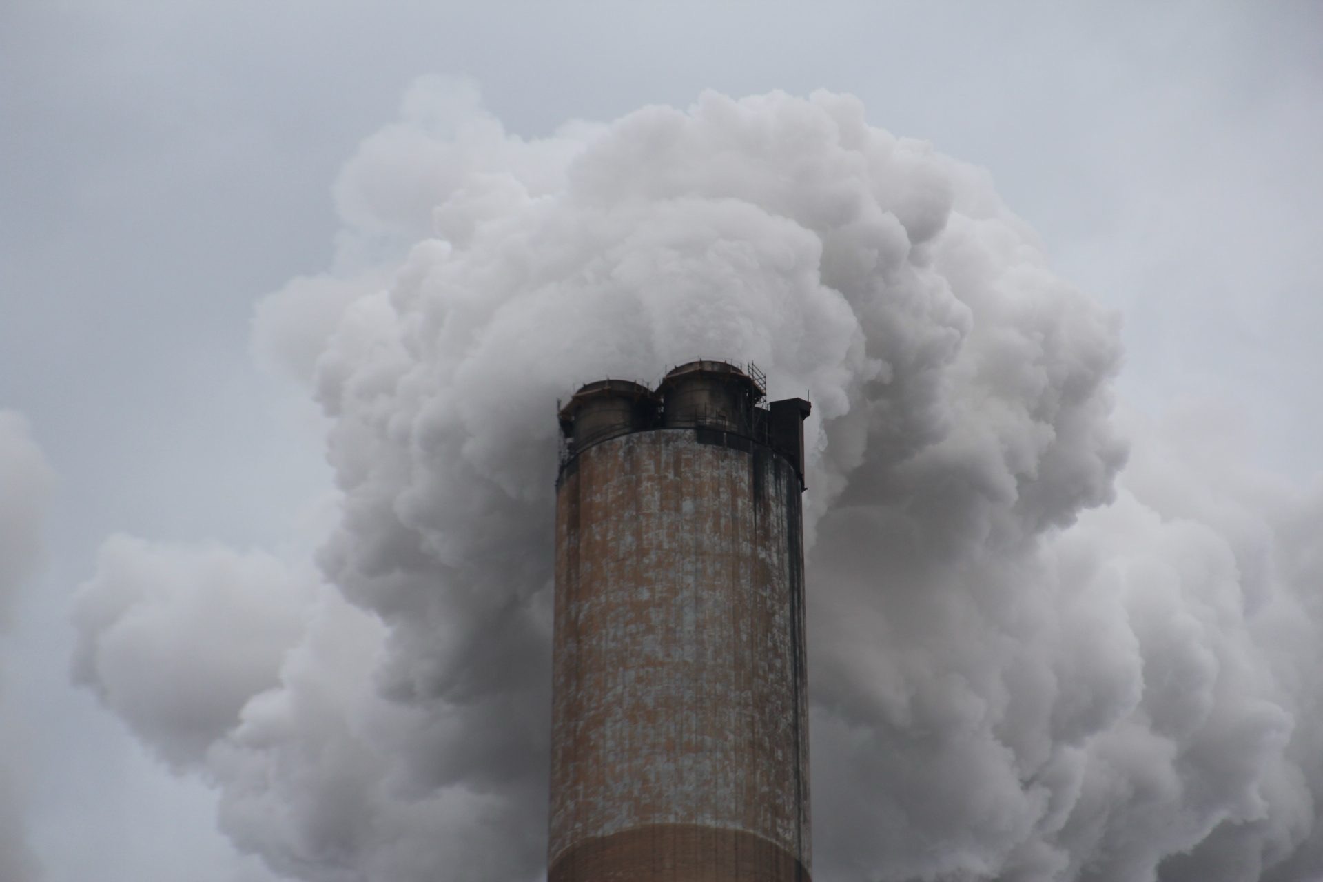 Close-up of smoke billowing out of a smokestack.