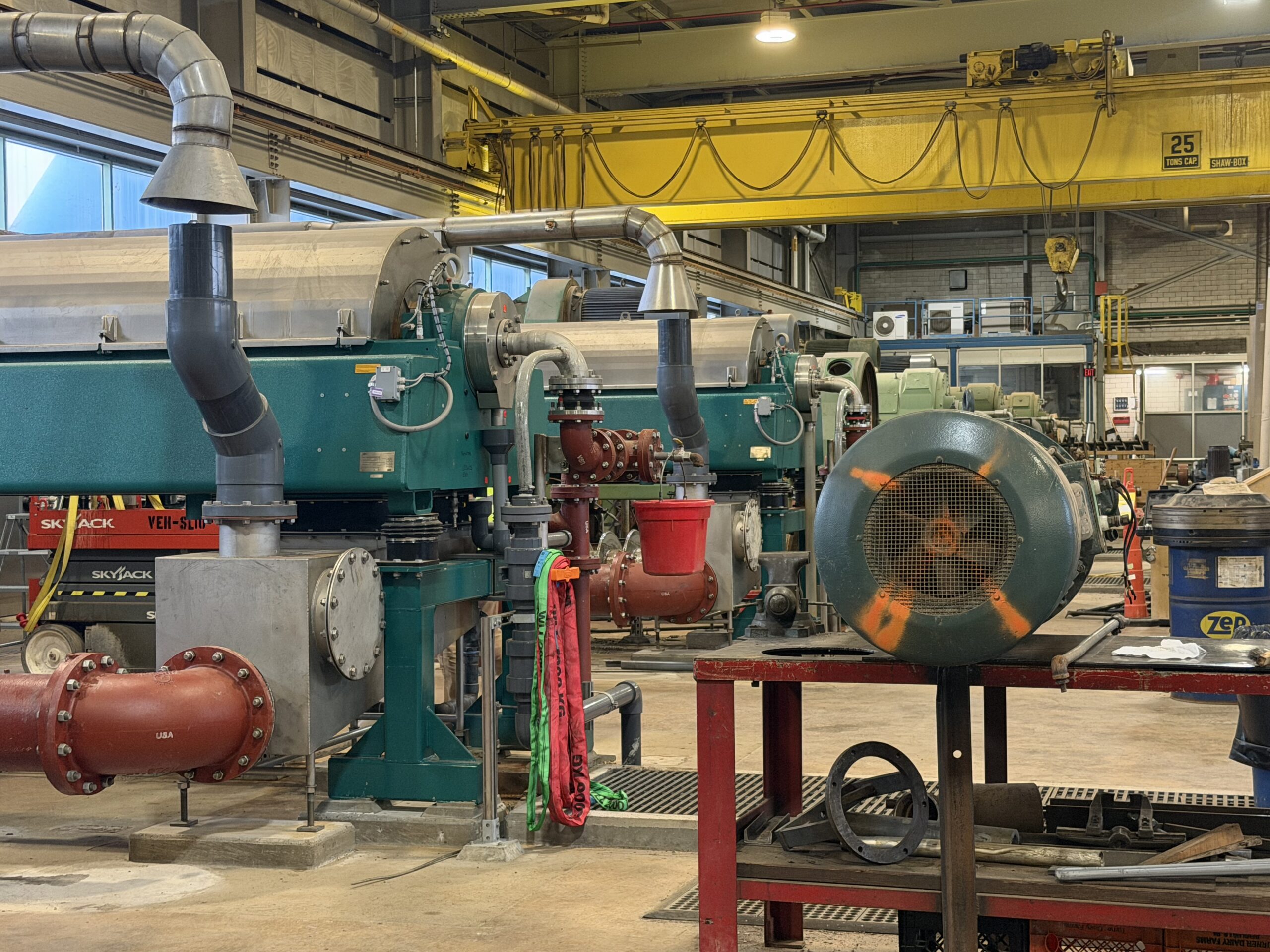 An industrial setting, turquoise colored round machines
