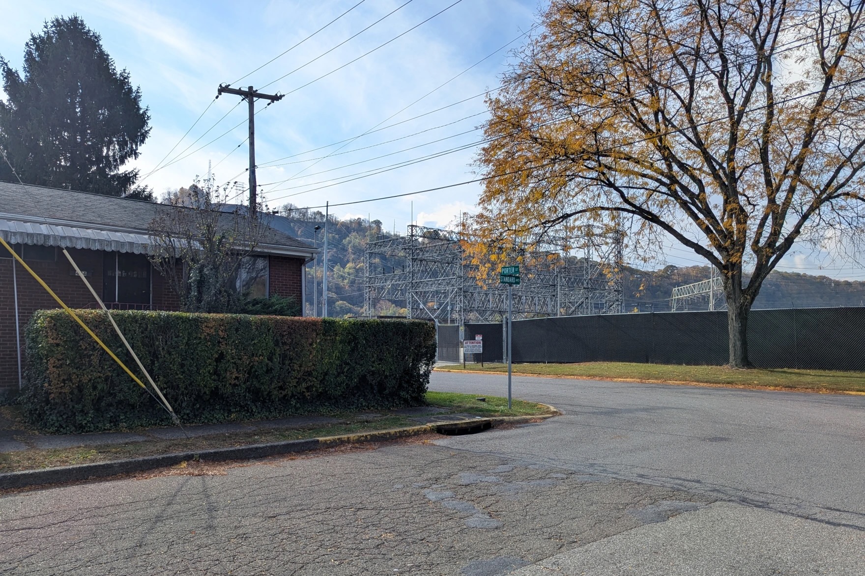 A house with an industrial facility across the street.