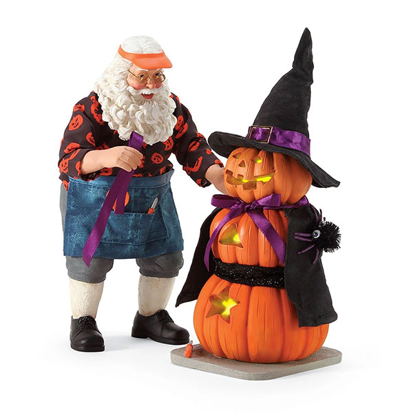 Santa figure standing with a pumpkin witch.