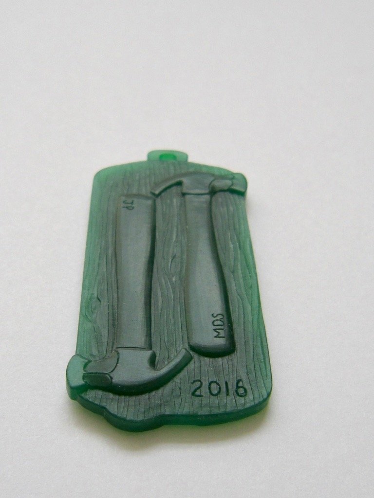 Wax carving with hammers facing outwards.