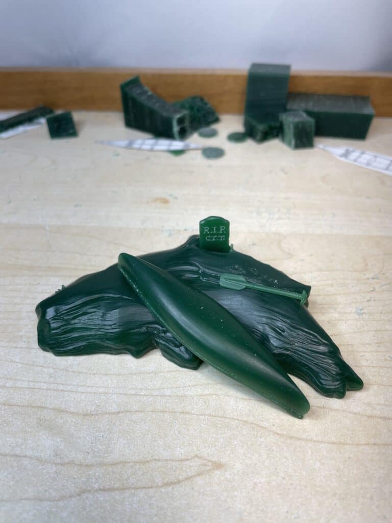 Finished wax carving of Canoe, Paddles, Island and Tombstone