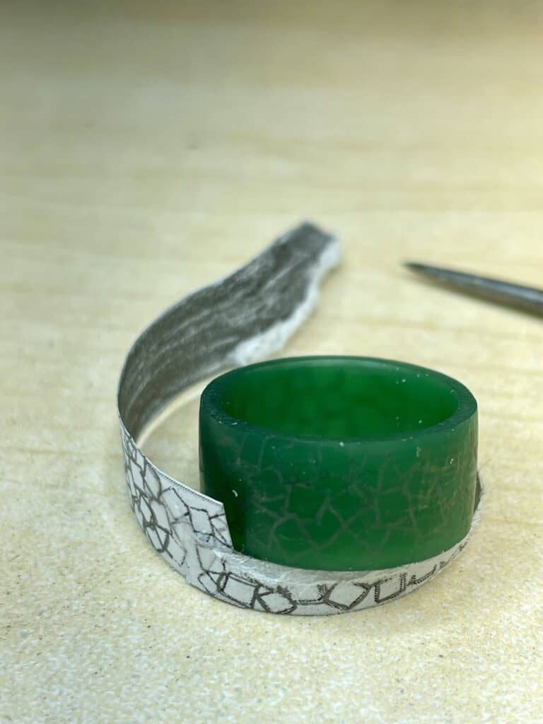 Paper, and wax ring with graphite transfer on the surface, ready for engraving