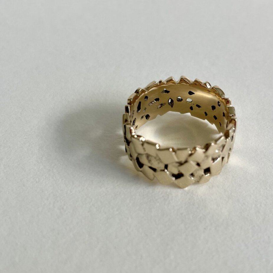 Gold ring composed of a collection of many cubes.