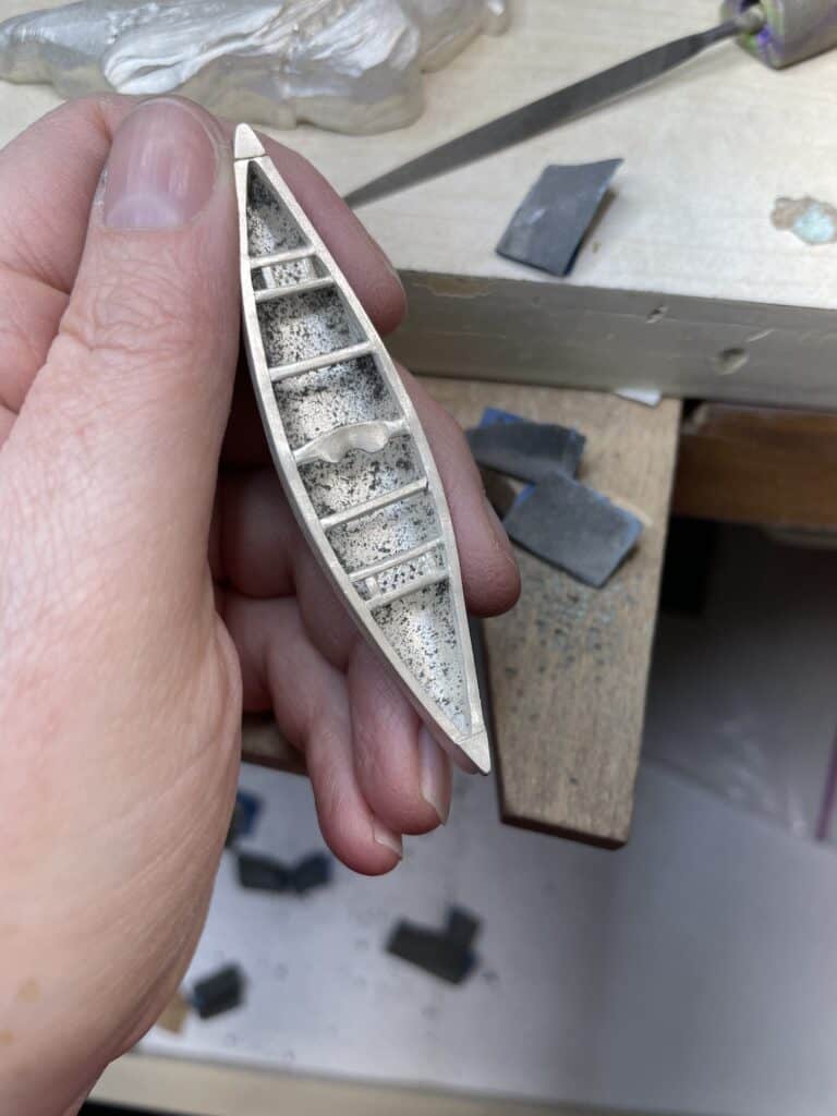 Finishing a sterling silver canoe at the bench