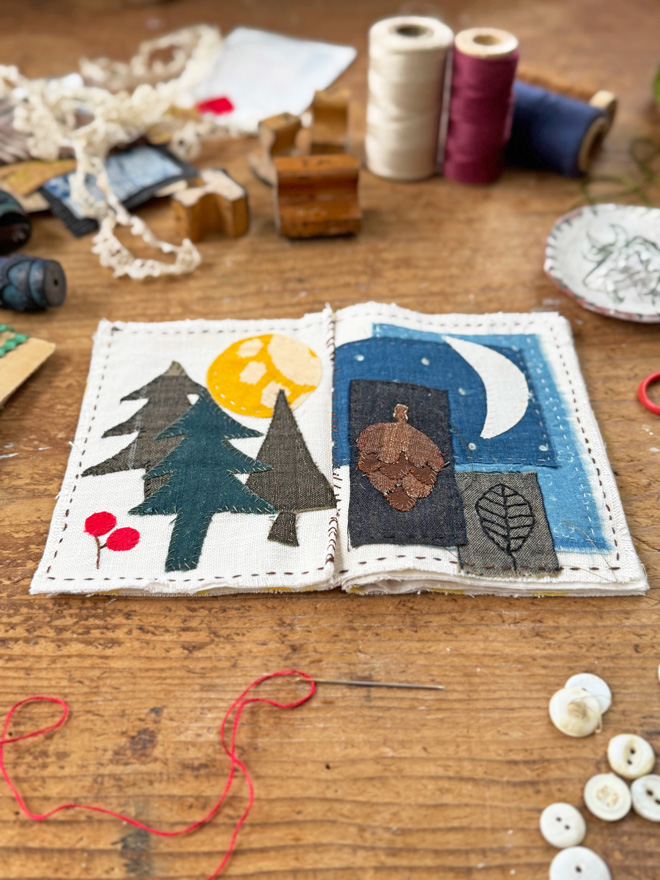 stitch book with applique of forest scenes