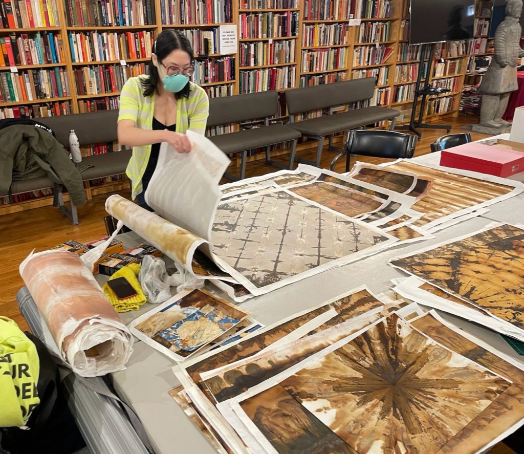 Mari MIller sorting through prints on a table