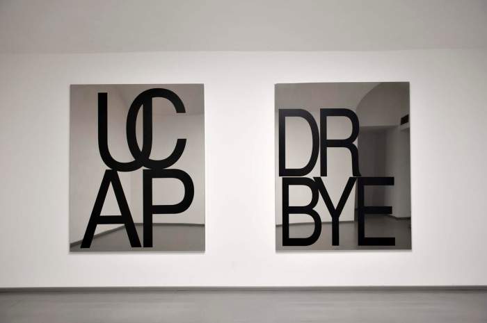 Be Andre, R BYE (don’t believe everthing you read), 2014, vinyl lettering on polished stainless steel, 180 x 145 cm & UCAP, 2014, stainless steel, 180 cm x 145 cm.